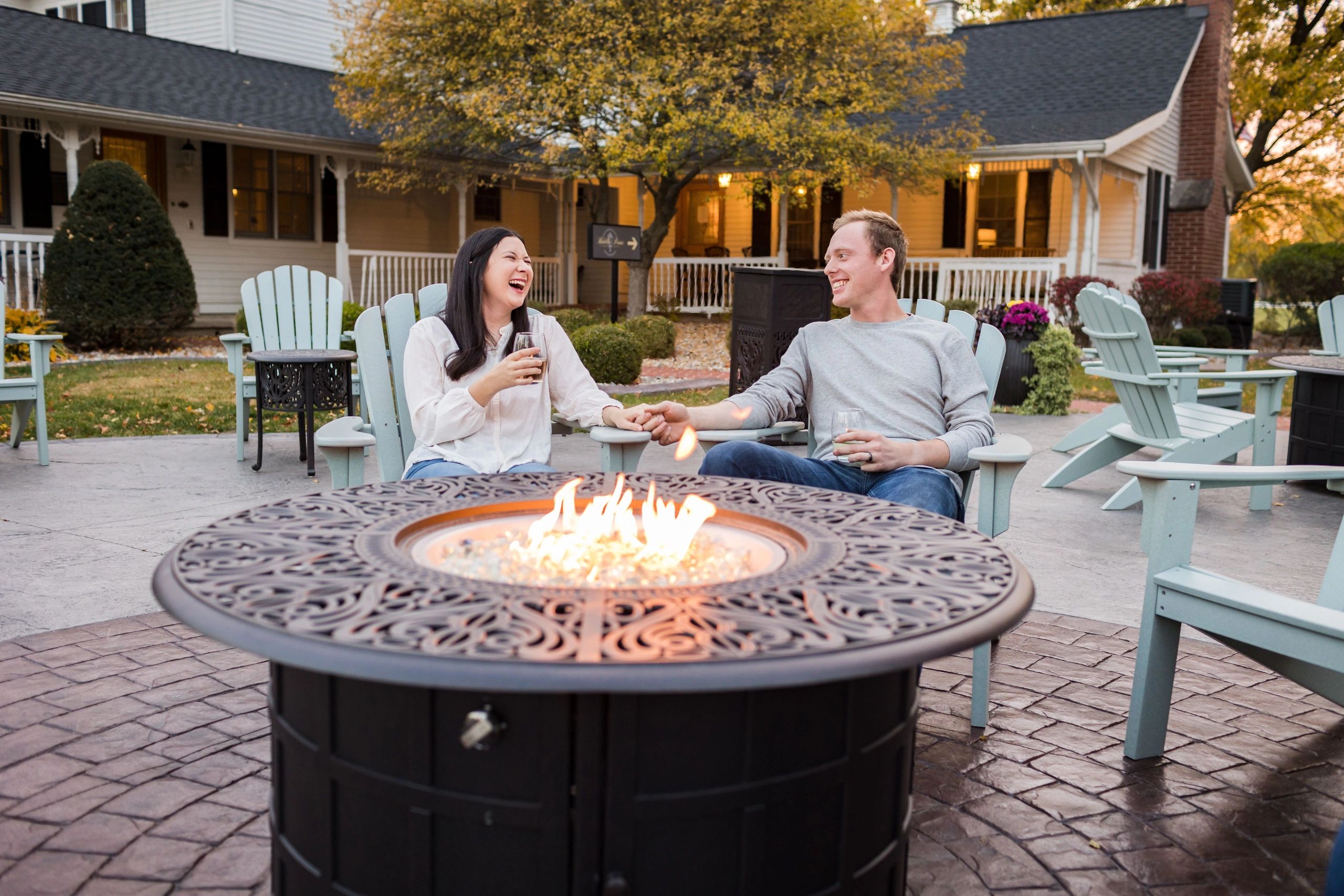Couple laughing on patio in fall